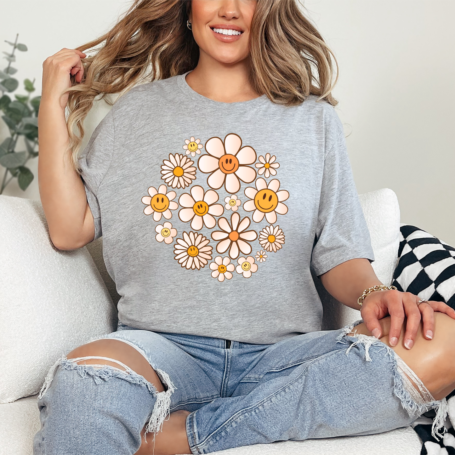 Woman wearing a gray t-shirt with floral design.